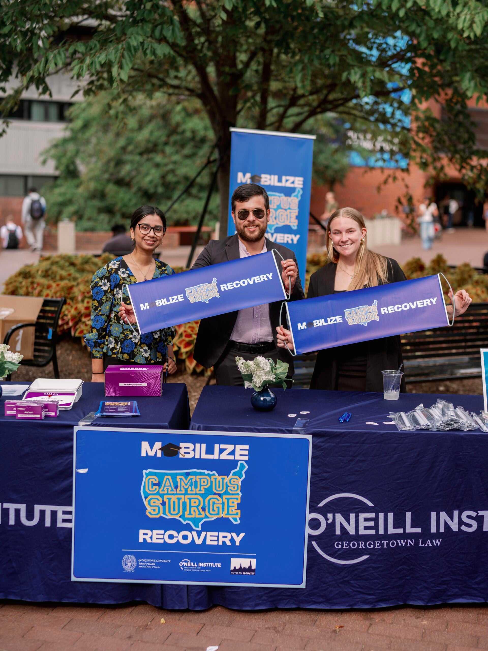 Current students Salomon Shool and Samantha Grimes (MS 2026) post with Mobilize Recovery flyers at the check-in table. Current students Salomon Shool and Samantha Grimes (MS 2026) post with Mobilize Recovery flyers at the check-in table.