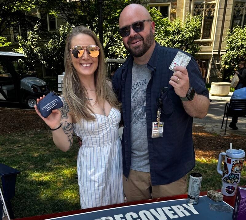 Co-president Amber Lashbaugh (MS ADPP 2026) and former president Thaddeus Weintzen (MS ADPP 2024) pose with doses of Naloxone.